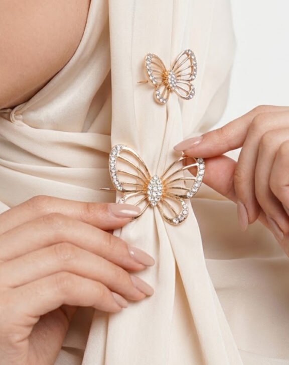 This all-white Rhinestone Butterfly Hijab Pin Set features two elegant butterfly designs fully covered in sparkling crystals, perfect for adding sophistication to any hijab style. Features: Gold-tone finish Full rhinestone coverage Set of 2 (large + small) Ideal for hijab, abaya, or shawl Why You Should Buy: The all-white crystal design keeps it versatile enough to match any outfit or hijab color. Perfect For: Formal and casual wear Hijab and abaya styling Gifting
