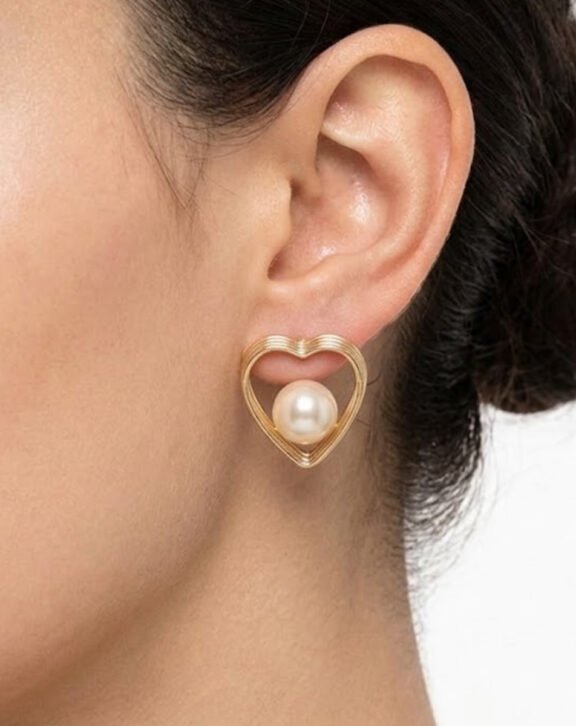 This Pearl Heart Stud Earring features a delicate gold wire heart outline with a single faux pearl center, offering a simple yet elegant everyday piece. Features: Gold tone finish Faux pearl accent Lightweight heart design Comfortable for daily wear Why You Should Buy: A minimal, elegant piece that works for everyday wear while still feeling special. Perfect For: Everyday wear Office/college styling Gifting