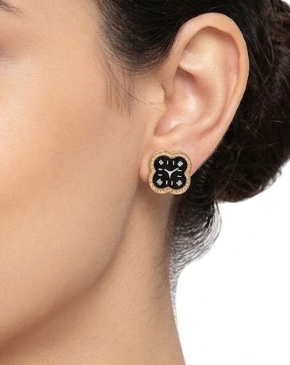This Clover Clock Stud Earring features a unique quatrefoil (clover) design styled like a mini clock face, finished with black enamel and a crystal-lined border. Features: Gold tone finish with black enamel Crystal-lined border Quirky clock-inspired design Lightweight stud Why You Should Buy: A one-of-a-kind design that's perfect for anyone who loves unique, conversation-starting jewellery. Perfect For: Everyday statement wear Gifting Unique jewellery collectors