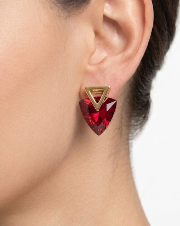 This Red Crystal Triangle Drop Earring features a bold faceted red crystal stone paired with a sleek gold triangle stud for a striking, eye-catching look. Features: Gold tone hardware Deep red faceted crystal Geometric triangle silhouette Statement-making design Why You Should Buy: The rich red color makes this a bold choice for festive occasions and statement styling. Perfect For: Festive occasions Evening wear Gifting